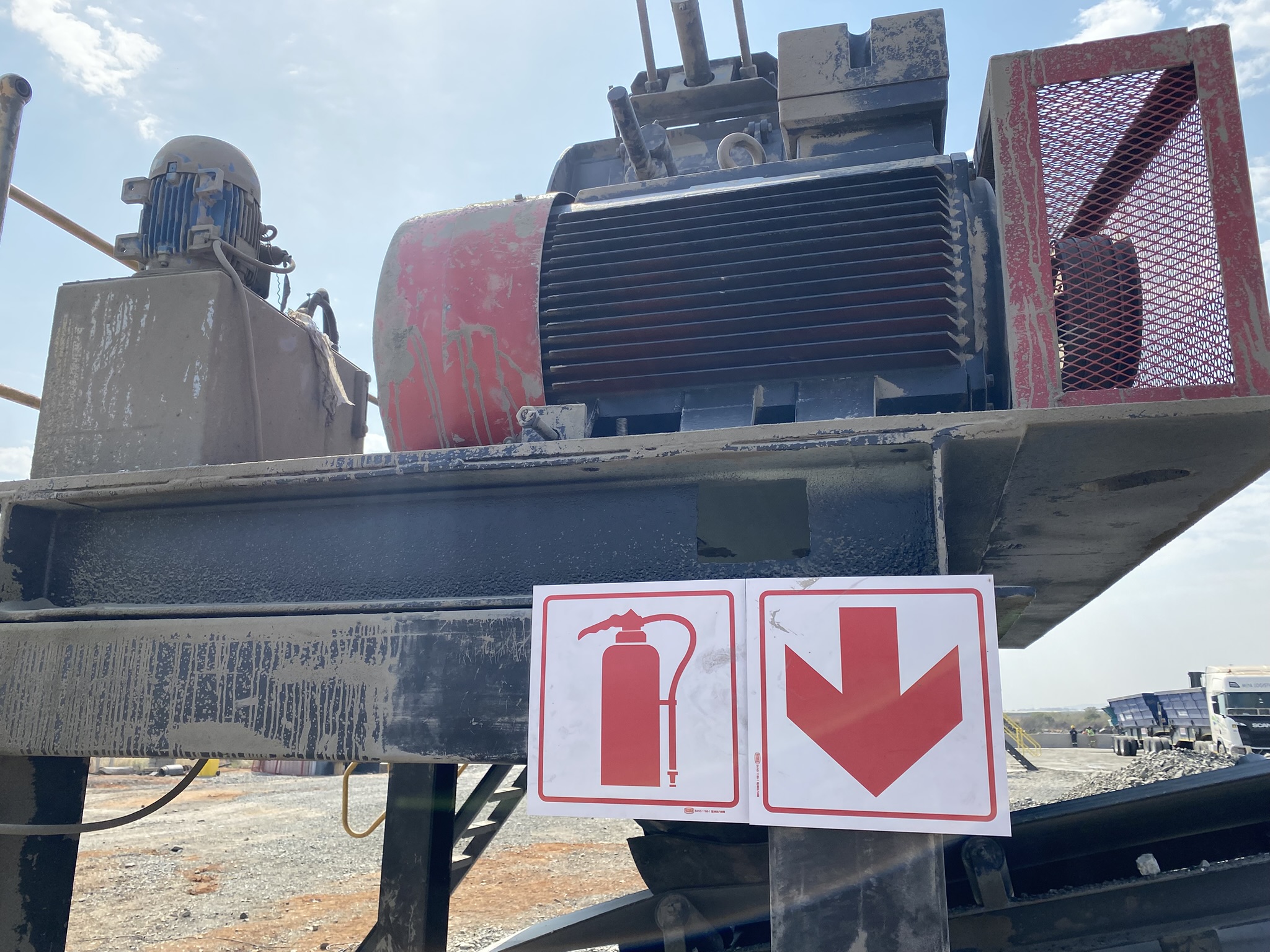Electric crusher motor installed on industrial crushing equipment at the plant.